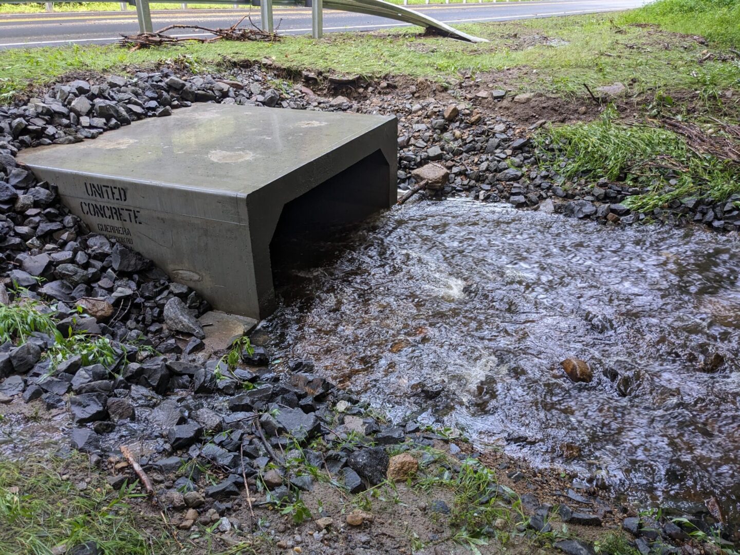 A concrete block sitting in the middle of a puddle.