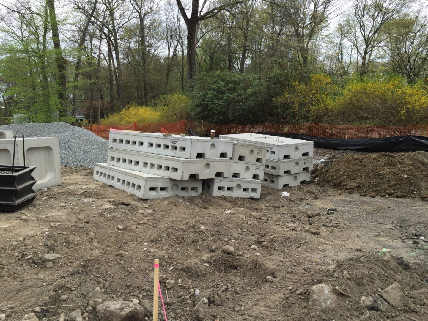 A pile of concrete blocks sitting on top of a dirt field.